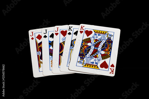 Full House hand in poke with jacks and kings on a black background. Isolated poker hand. Gambling card games. photo