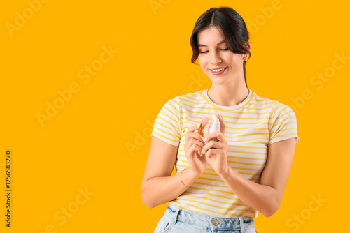 Young woman applying face f...