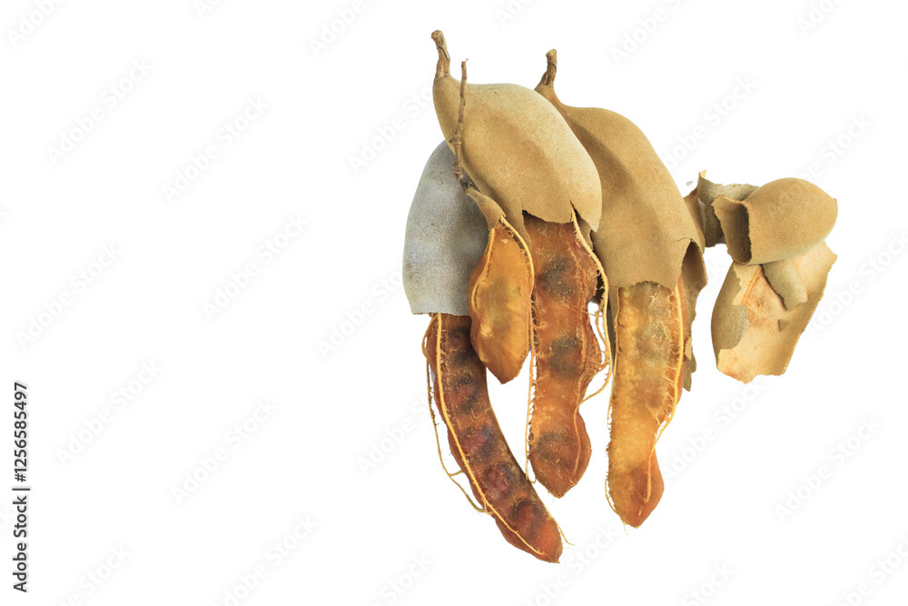 Fototapeta premium Cutout sour tamarind on white background. The variety with a sour taste comes from tartaric acid. Fresh pods are used in cooking to add sourness, mature pods are used to make tamarind paste.