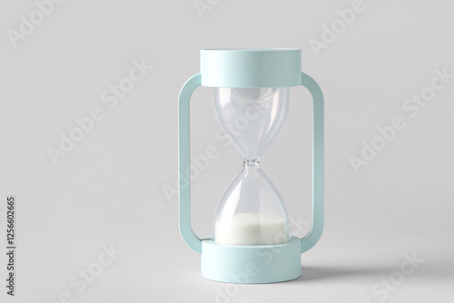 Modern hourglass on grey background. Time management concept photo