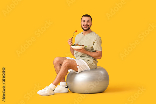 Sporty young man sitting on...