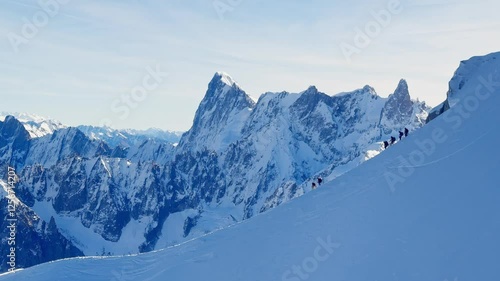 Wallpaper Mural View from the cable car ascending to Aiguille du Midi, with paragliders descending the snowy slopes, preparing for a jump between the stunning peaks of the French Alps, with Mont Blanc in the distance Torontodigital.ca