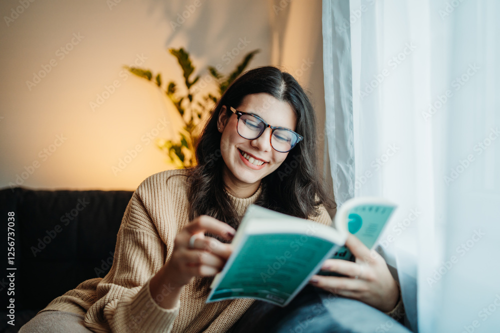 Young caucasian woman reading book or learning by the window Young caucasian woman reading book or learning by the window