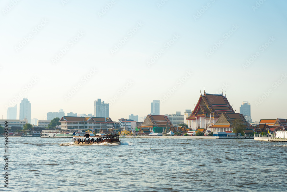 Naklejka premium Wat Kanlayanamit Buddhist temple on the bank of the Chao Phraya River early morning in Bangkok