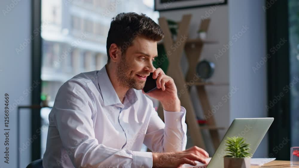 Positive corporate worker calling mobile phone at modern workplace closeup. Positive corporate worker calling mobile phone at modern workplace closeup.