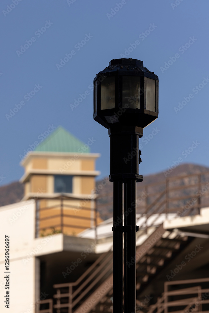 A historic street lamp frames the downtown skyline of Burbank, California, USA. A historic street lamp frames the downtown skyline of Burbank, California, USA.
