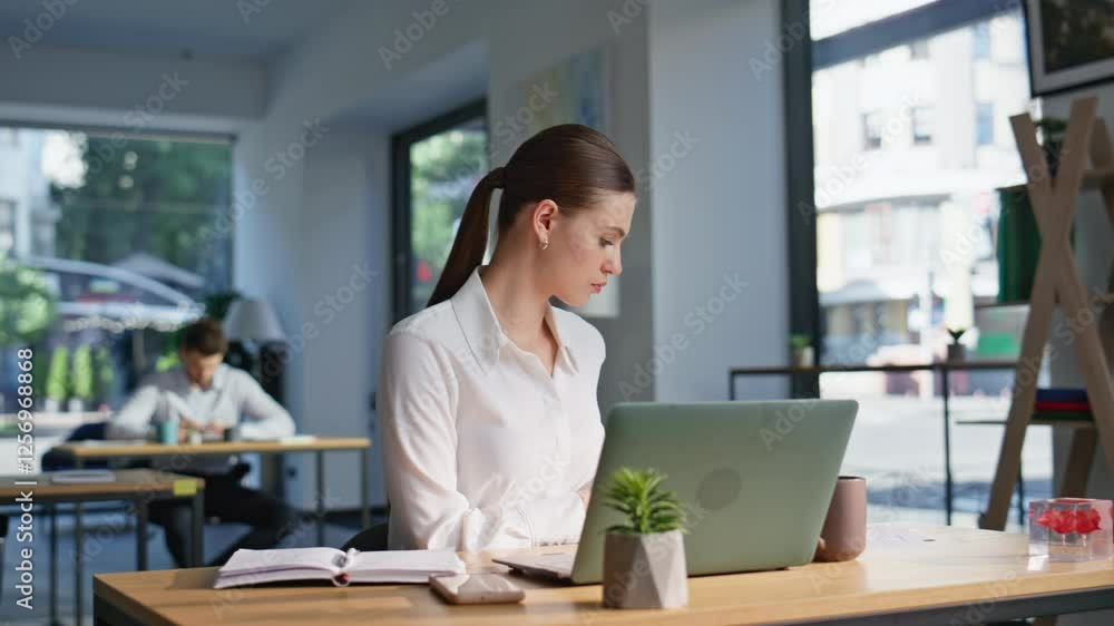Joyful employee satisfied successful work reading financial report at office. Joyful employee satisfied successful work reading financial report at office.