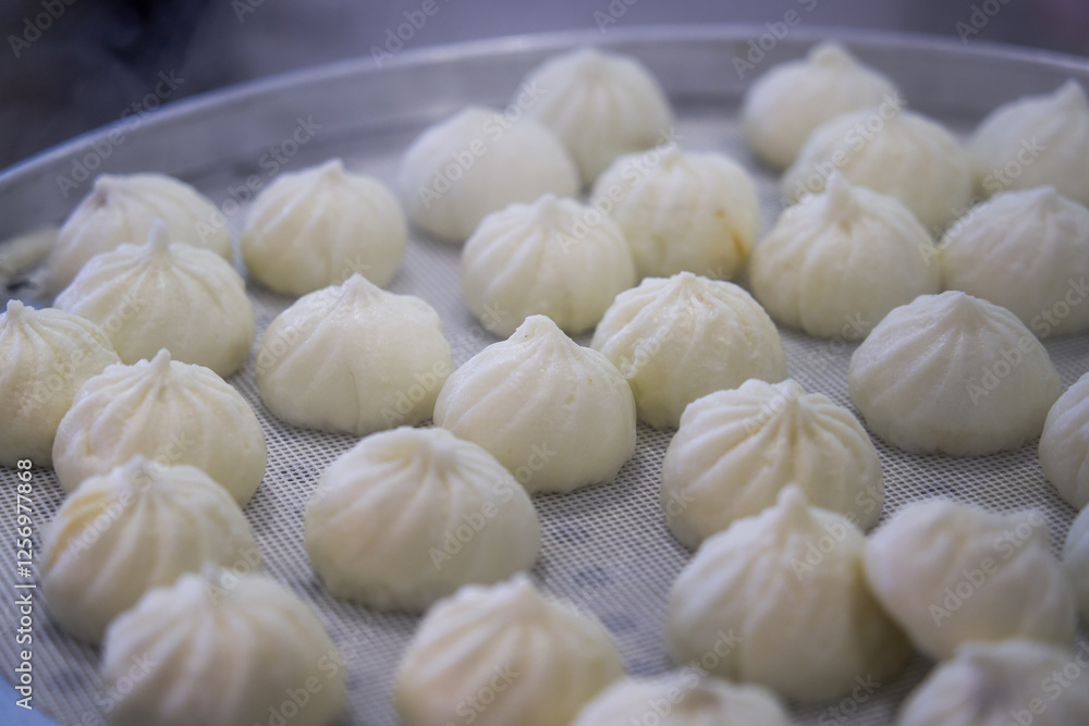 Close-up of steaming steamed buns and siomai in breakfast shop Close-up of steaming steamed buns and siomai in breakfast shop