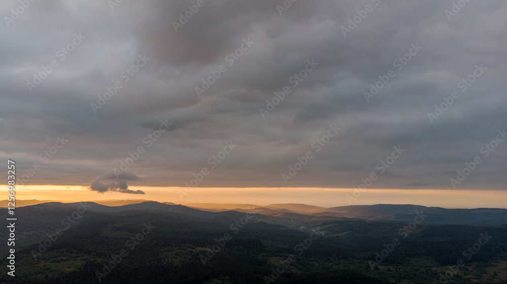 Majestic Mountains, Dense Forest, And Dramatic Clouds Illuminated By A Stunning Sunset. Aerial View Capturing The Breathtaking Beauty Of Nature From A Bird’s-Eye Perspective. Majestic Mountains, Dense Forest, And Dramatic Clouds Illuminated By A Stunning Sunset. Aerial View Capturing The Breathtaking Beauty Of Nature From A Bird’s-Eye Perspective.