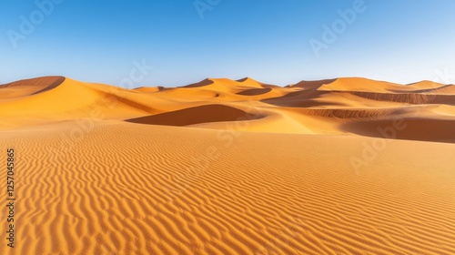 Stunning desert landscape featuring golden sand dunes under a clear blue sky, showcasing natural beauty and tranquility.
