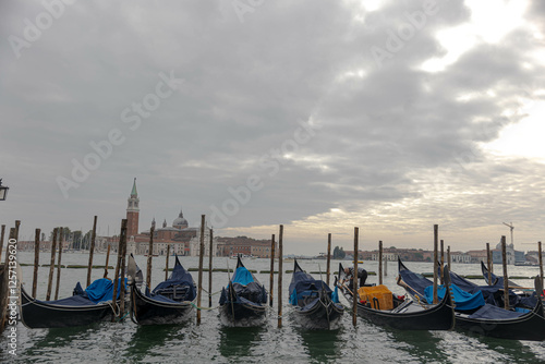 Gondolas lined up looking out onto Grand Canal, Venice
