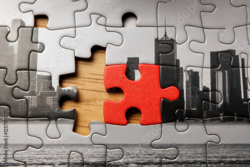 A nearly completed puzzle featuring a single piece with a contrasting color, illustrating the final touch of innovation