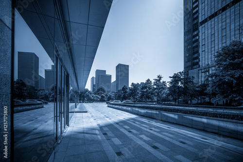 Obraz na płótnie Contemporary Urban Landscape in Blue Tones with Modern Architecture and Greenery