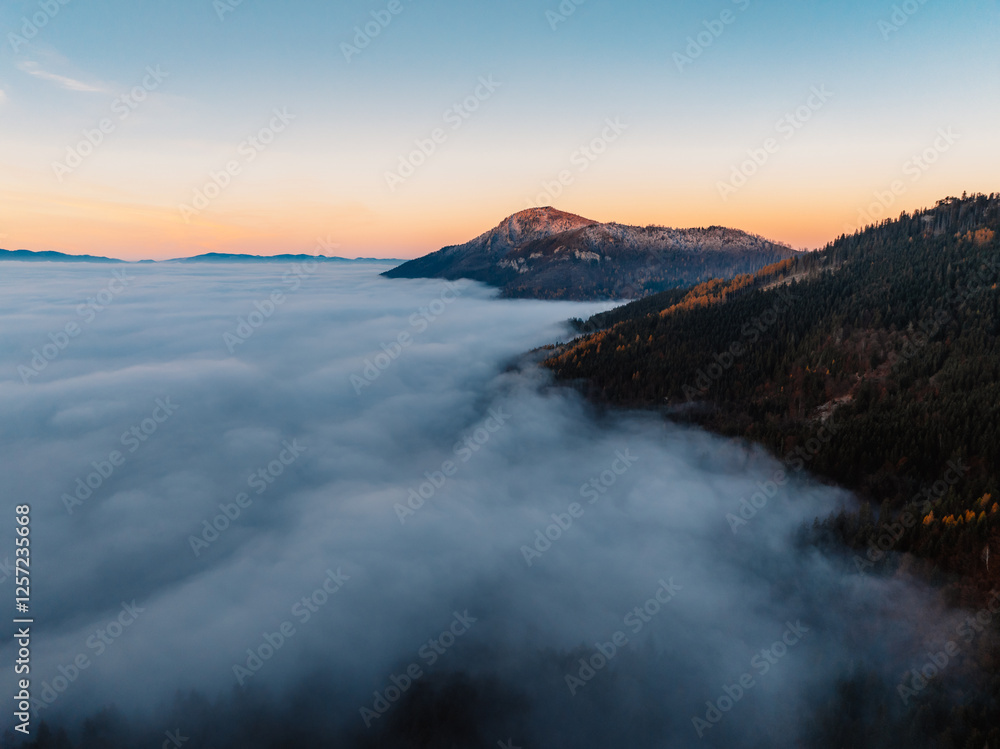 Naklejka premium Misty morning in Liptov region with High Tatras mountains around. Liptovsky Mikulas landspace, slovakia.