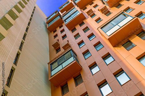 Wallpaper Mural apartment building with colorful facades. Modern minimalistic architecture with lots of square glass Windows and flowers on the building. Moscow, Russia Torontodigital.ca