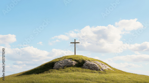 Cross on a Hilltop: A solitary wooden cross stands tall against a backdrop of a cerulean sky and fluffy clouds, perched atop a grassy hill with two weathered rocks flanking its base.