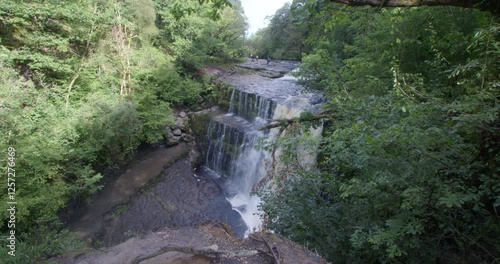 wide shot of Sgwd Clun-Gwyn Waterfall on the river Mellte at the Brycheiniog, Brecon Beacons photo