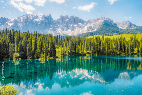 Karersee mountain lake in the Dolomites landscape, South Tyrol alps, Italy, also known lake Carezza. Reflection green on lake. photo