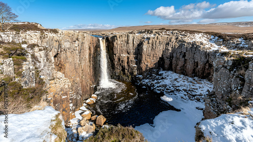Waterfall in snowy highlands, winter landscape, scenic view