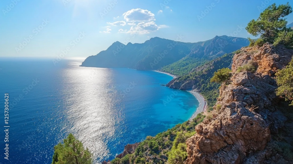 Fototapeta premium Verdant mountains under a bright, sunny sky, with the clear sea sparkling in the sunlight. 