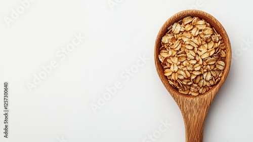 Wooden spoon holding oatmeal, studio shot, white background photo