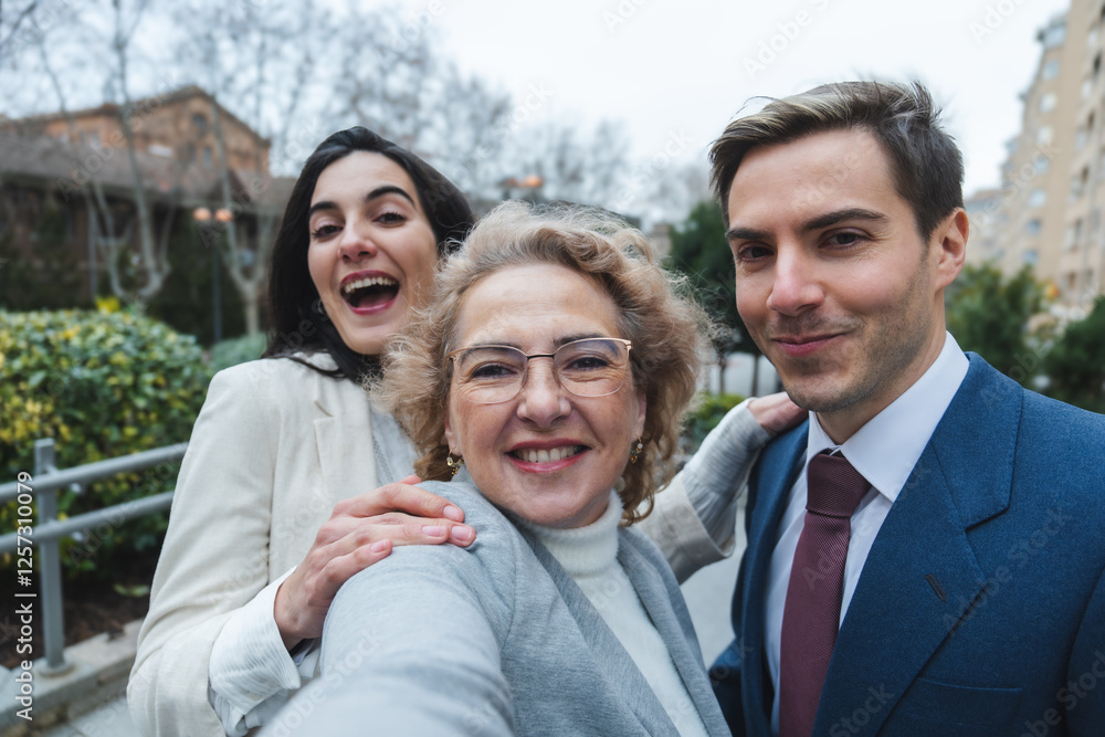 Happy family taking a selfie outdoors in urban setting