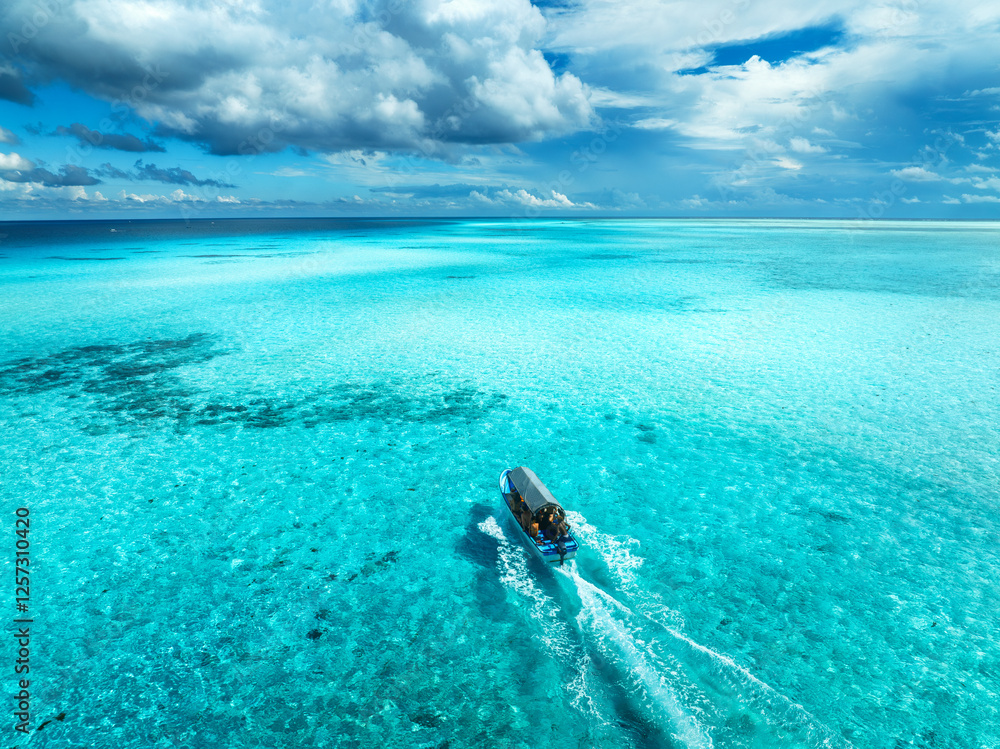 Aerial view of floating boat in turquoise water on sunny day Aerial view of floating boat in turquoise water on sunny day