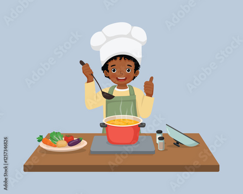 Cute little African boy chef cooking delicious vegetable soup showing thumb up
