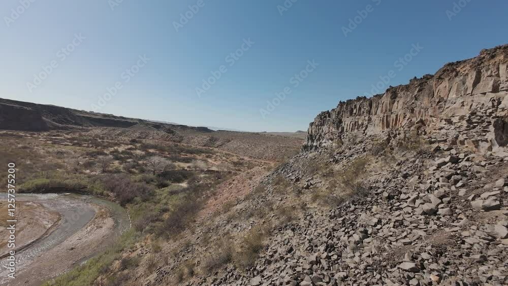 Aerial Virgin River gorge volcanic ruins. Southwestern desert Utah St George. Red stone black volcanic mountain landscape. Geological landscape weather carved erosion, spectacular beautiful mountain. Aerial Virgin River gorge volcanic ruins. Southwestern desert Utah St George. Red stone black volcanic mountain landscape. Geological landscape weather carved erosion, spectacular beautiful mountain.