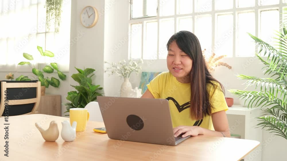 Young woman working on laptop at home office Young woman working on laptop at home office