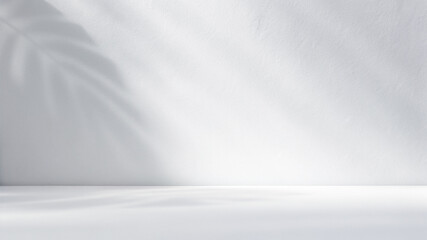 Minimalistic simple background for product presentation. Shadow from tropical foliage and light on gray wall.