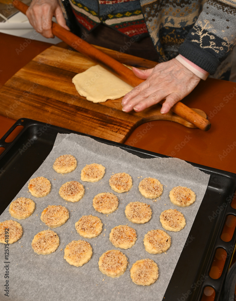 Baking cookies with rolled dough on a wooden surface in a cozy kitchen during the evening