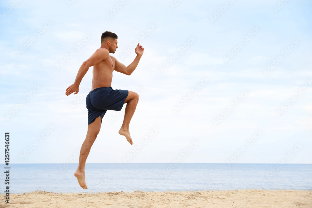 Muscular man doing exercise on beach, space for text. Body training Muscular man doing exercise on beach, space for text. Body training
