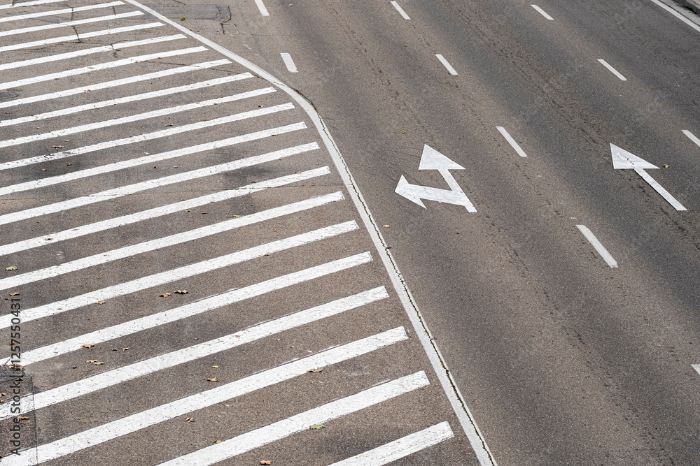 Curved highway lanes with directional arrows and clear road markings in an urban setting. Curved highway lanes with directional arrows and clear road markings in an urban setting.