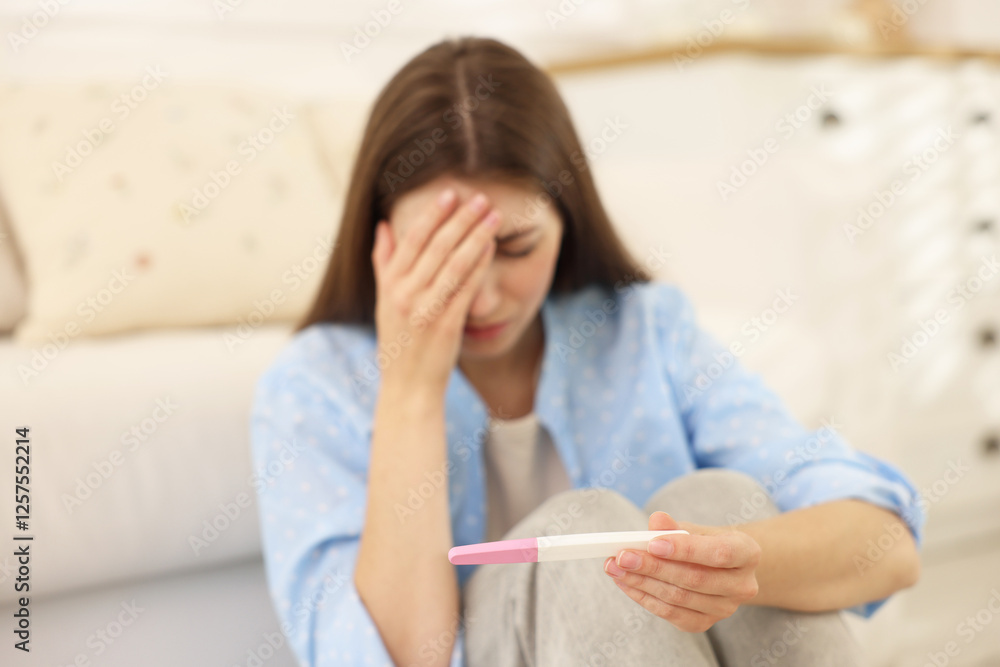 Upset woman with negative pregnancy test at home, selective focus Upset woman with negative pregnancy test at home, selective focus