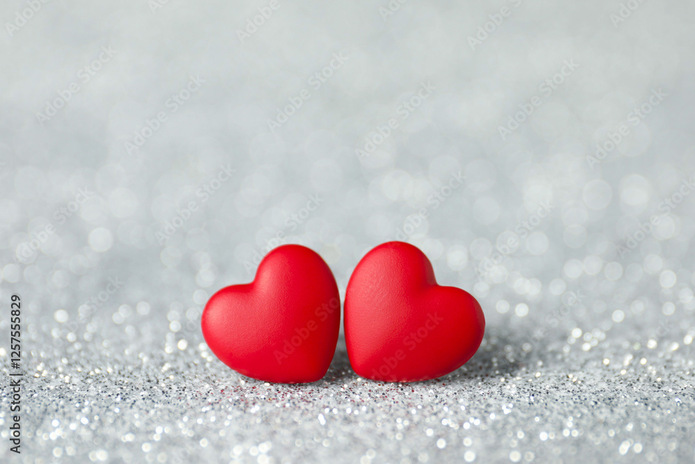 Fototapeta premium Red decorative hearts on shiny silver background. Happy Valentine's day