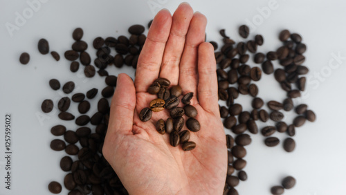  Coffee beans on the palm of the hand, with a coffee background