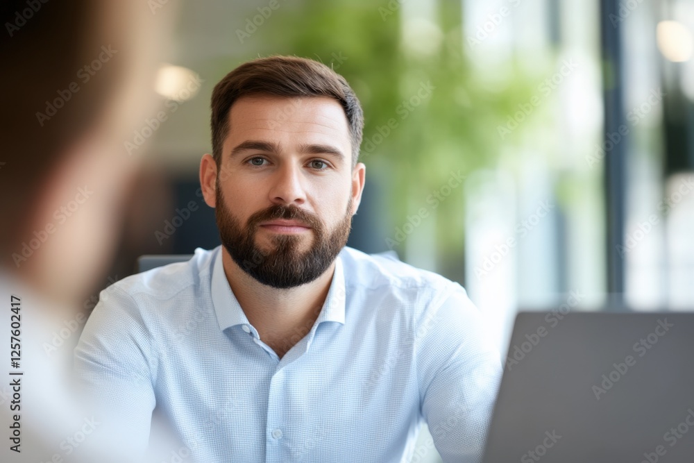 serious businessman looking at viewer during meeting serious businessman looking at viewer during meeting