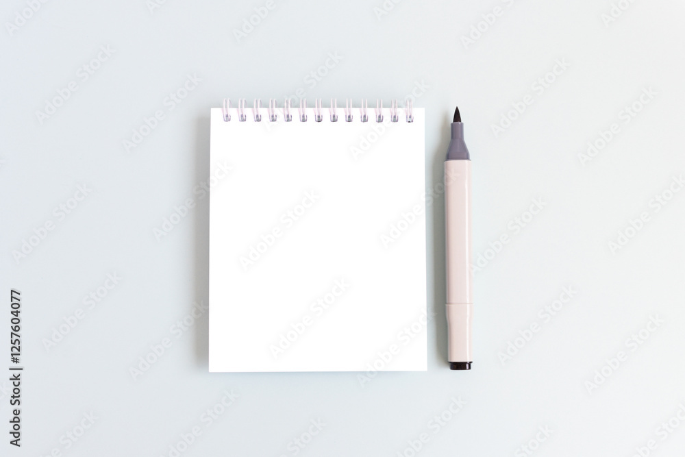 Clean notepad mockup and felt tip pen on a blue background. Empty notebook template. Clean notepad mockup and felt tip pen on a blue background. Empty notebook template.