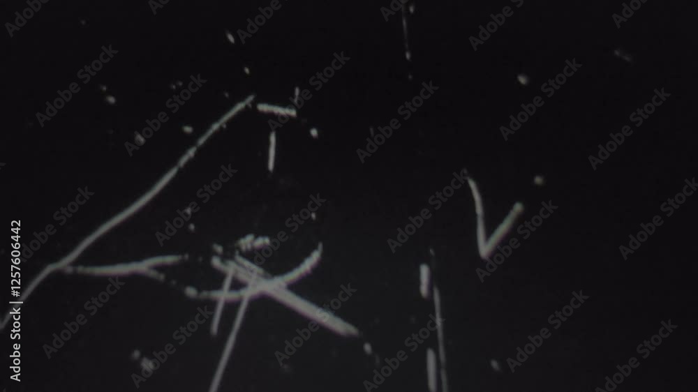 Close-Up of Scratches on Black Surface Creating a Vintage Film Effect Close-Up of Scratches on Black Surface Creating a Vintage Film Effect