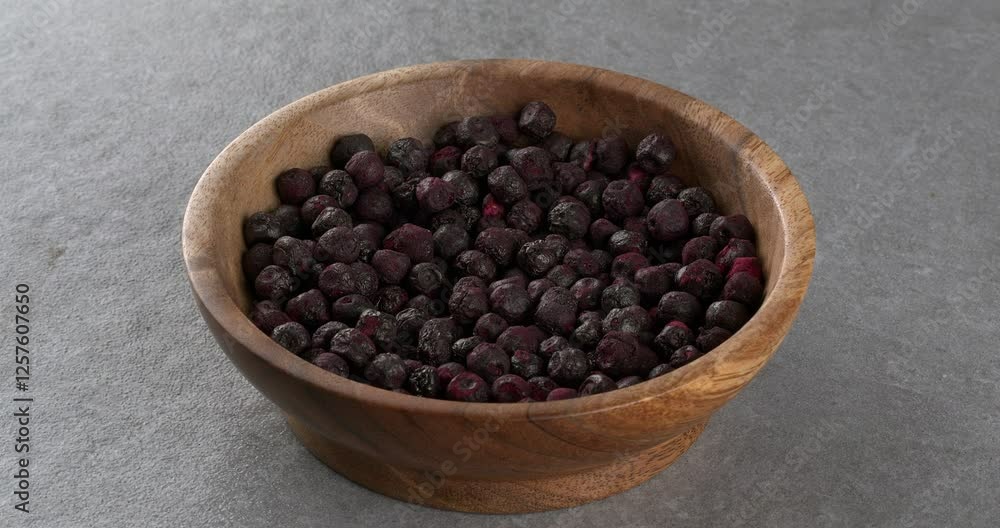 Freeze dried blueberries in a wooden bowl. Close-up footage on the rotating table. Freeze dried blueberries in a wooden bowl. Close-up footage on the rotating table.