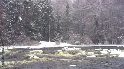 Wallpaper Mural Experience a breathtaking flight over the frigid waters of a river in Kotka, Finland, framed by dense forests and snow-covered banks during winter's chill.	 Torontodigital.ca