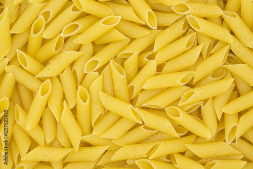 Penne pasta close-up. horizontal top view of uncooked pasta