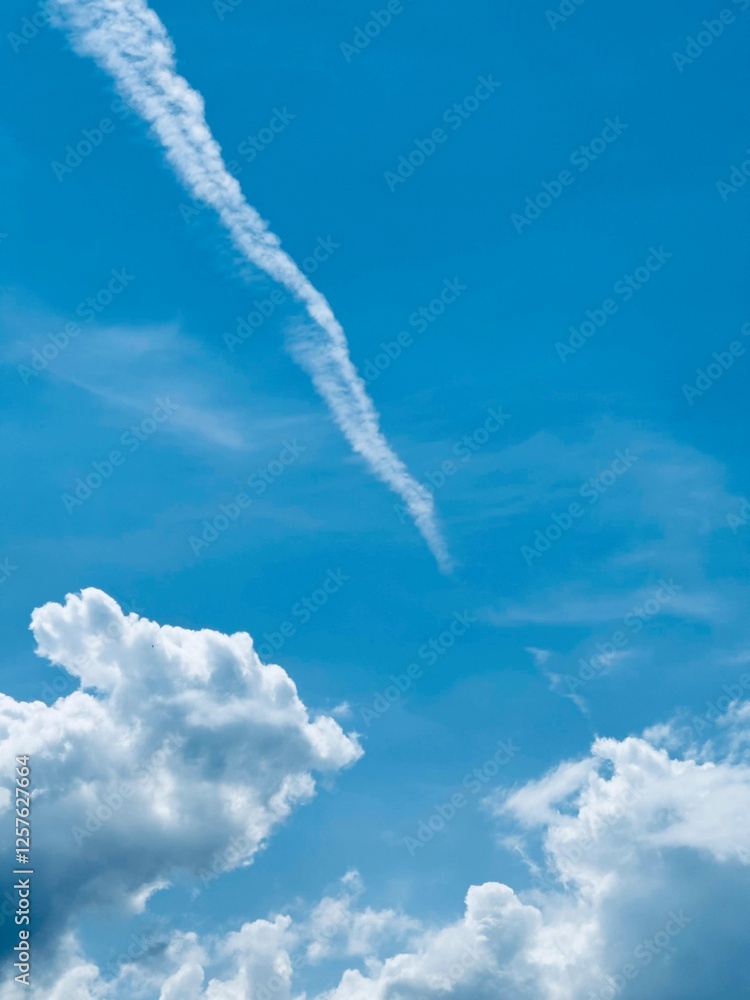 Blue Sky with White Clouds and Airplane Contrail Blue Sky with White Clouds and Airplane Contrail