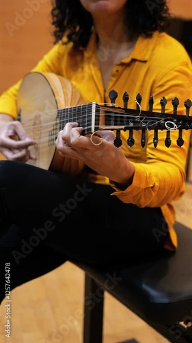 Wallpaper Mural Video of a woman playing the lute, close up look, no faces shown  Torontodigital.ca