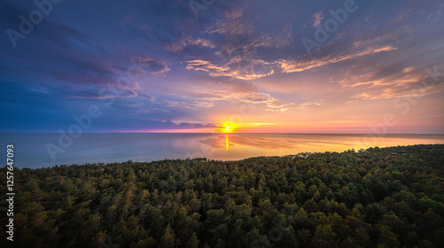 Fototapeta Naklejka Na Ścianę i Meble -  Colorful sunset over the Baltic sea. Dramatic storm clouds in vivid sunset colors. Sandy coast line with pine forest