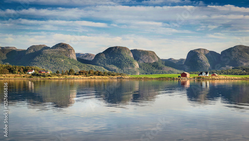 beautiful view on hills and a little village at the edge of the sea in Norway