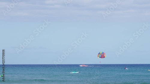 Colorful parasailing adventure over blue ocean waters