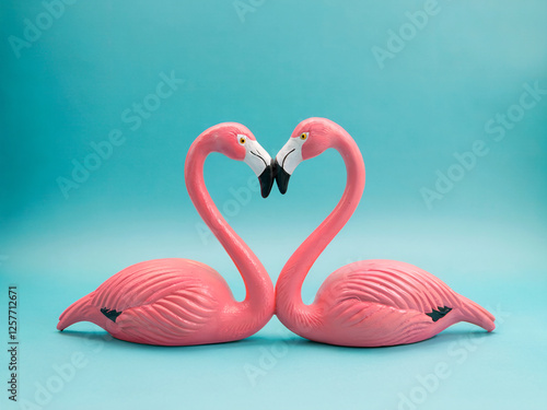Colorful Flamingos Forming a Heart Shape on a Bright Blue Background