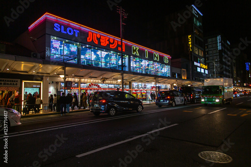 Pachinko parlor at night, in Japan, indicated by the neon sign featuring the word 